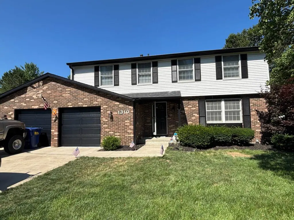 Two-story brick home with newly painted trim and dark accents in Brownsburg, IN