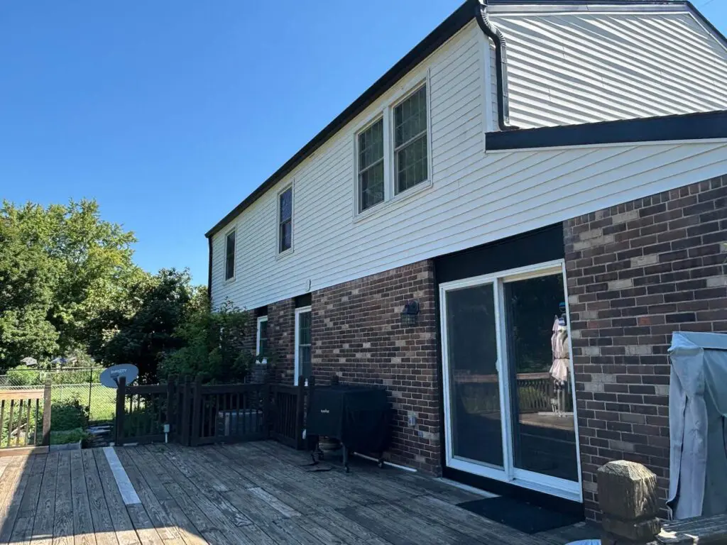 Exterior of a brick and siding home with rear deck painted by Integrity in Blue in Brownsburg, IN