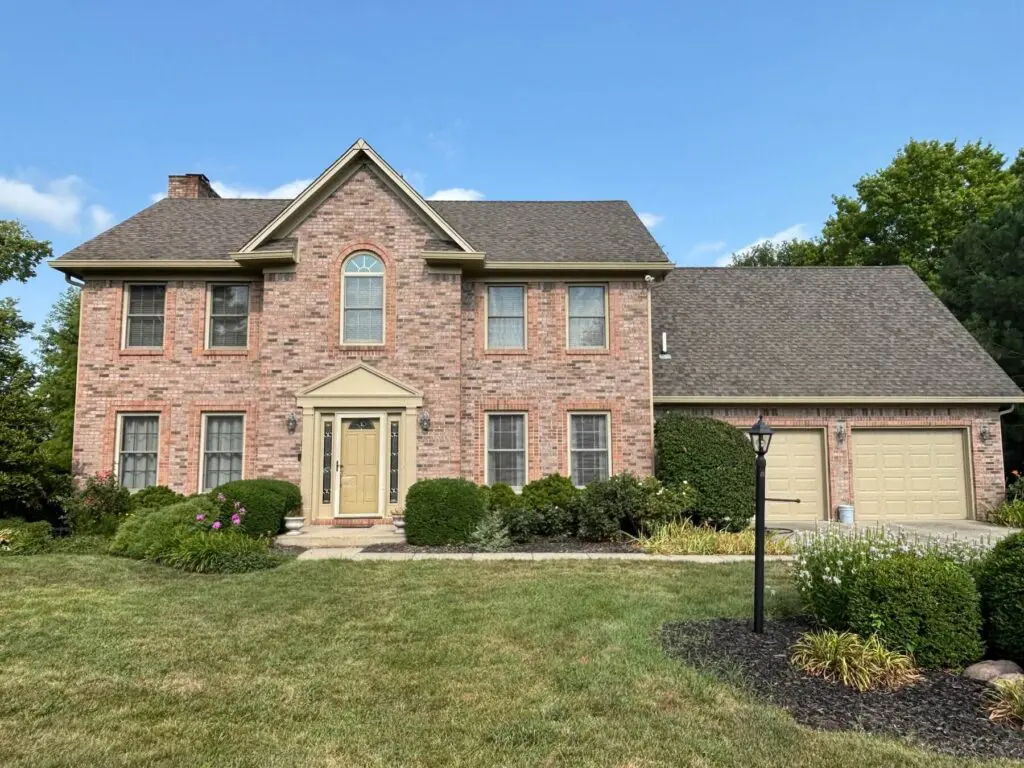 Two-story brick colonial home with freshly painted trim in Brownsburg, IN