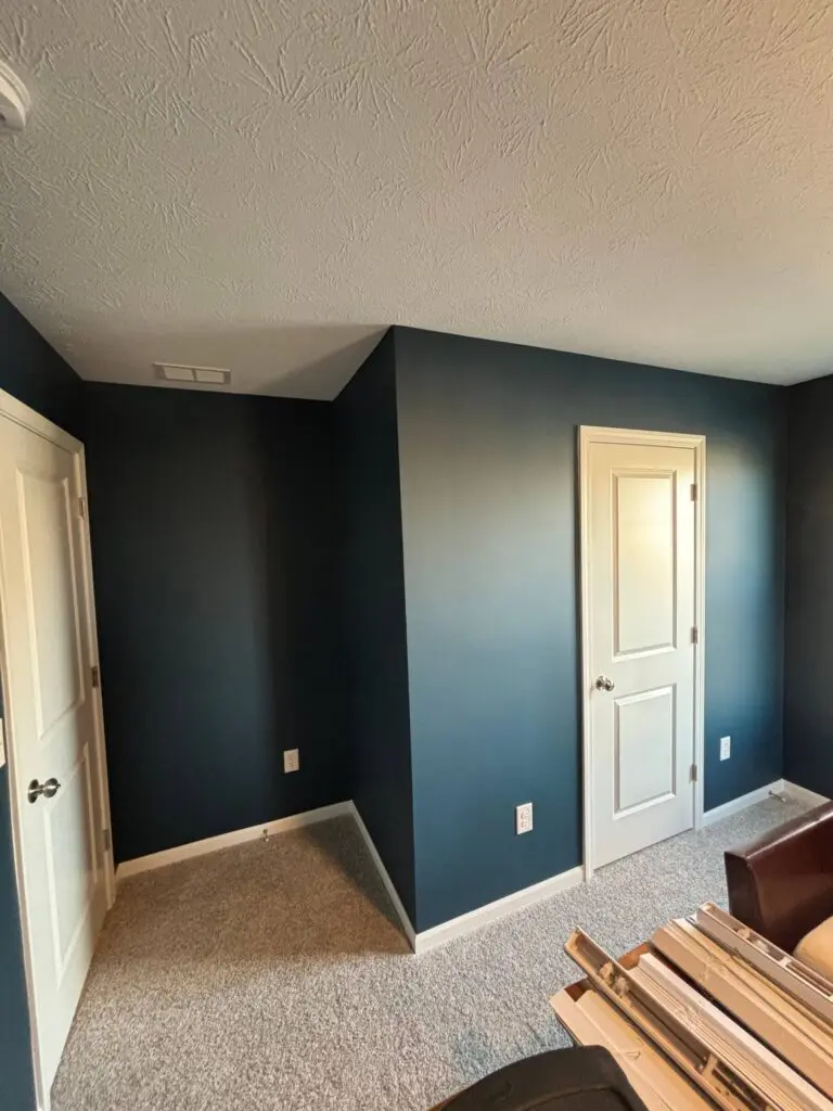Bedroom with newly painted deep navy blue walls in a Brownsburg, IN home